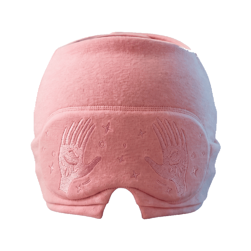 Sorluma migraine cap in coral pink with the eye mask up